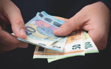 Man in a suit counts Euro banknotes. Business and finance, salary concept