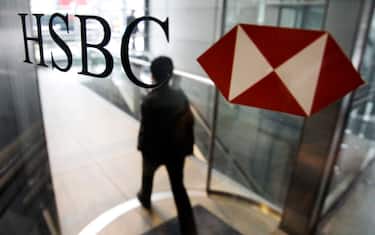 A man walks past a logo of HSBC Holdings PLC at the bank's headquarter in Hong Kong Monday, March 2, 2009.  HSBC PLC plans to scale back its consumer lending operations in the United States and to close hundreds of branches there, British and U.S. newspapers reported Sunday. The Financial Times and the Wall Street Journal said HSBC will announce the plans on Monday as it discloses its 2008 results and confirms a plan to raise 12 billion pounds ($17 billion) in a new rights issue.(AP Photo/Vincent Yu)
