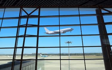 flight departing,the looking glass of modern airport terminal