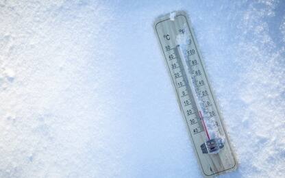 The thermometer on the snow shows low temperatures well below zero. Extreme winter freezing weather.