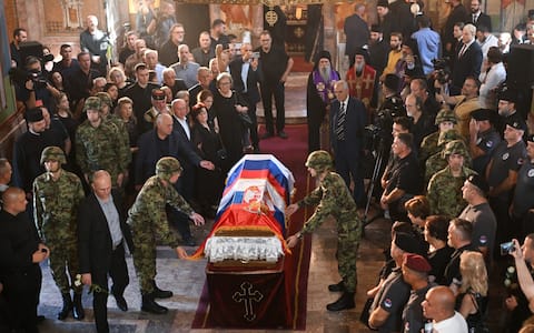 Mourners gather around the coffin of late Bosnian Serb military leader Ratko Mladic at the end of a funeral ceremony at St Lukas church in Belgrade on September 7, 2026. Mladic, 84, died last week after suffering several strokes while serving a life sentence in The Hague for war crimes committed during the 1990s war in Bosnia. (Photo by OLIVER BUNIC / AFP)