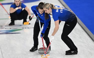 Stefania Costantini and Elena Mathis of Italy compete in the curling women's round robin between Italy and China during the Milano Cortina 2026 Winter Olympic Games at the Cortina Curling Olympic Stadium in Cortina d'Ampezzo on February 14, 2026. (Photo by Tiziana FABI / AFP via Getty Images)