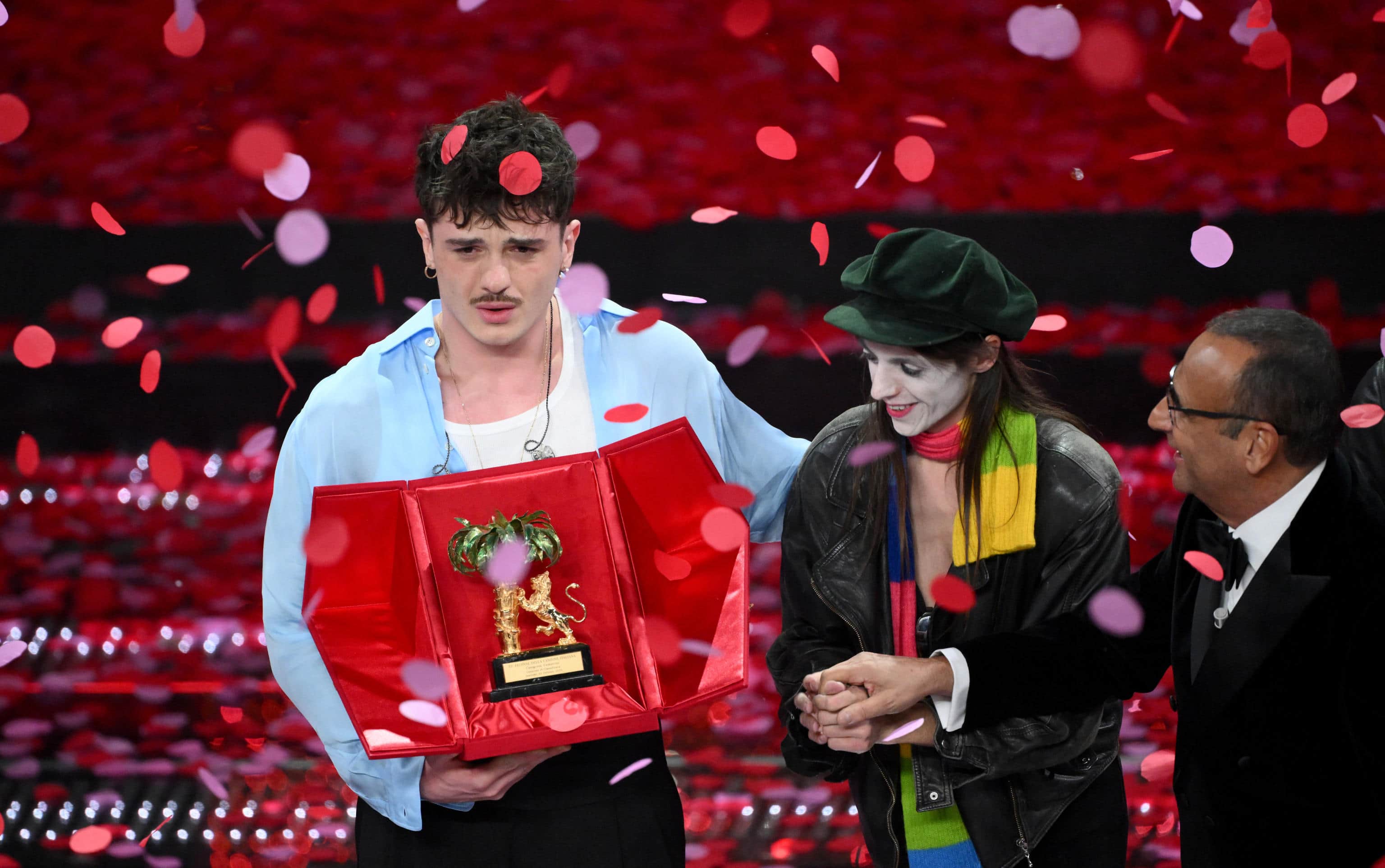 Italian singer Olly celebrates on stage after winning the 75th edition of the Sanremo Italian Song Festival with Italian singer Lucio Corsi and Sanremo Festival host and artistic director Carlo Conti in Sanremo, Italy, 15 February 2025. The music festival will run from 11 to 15 February 2025.  ANSA/ETTORE FERRARI