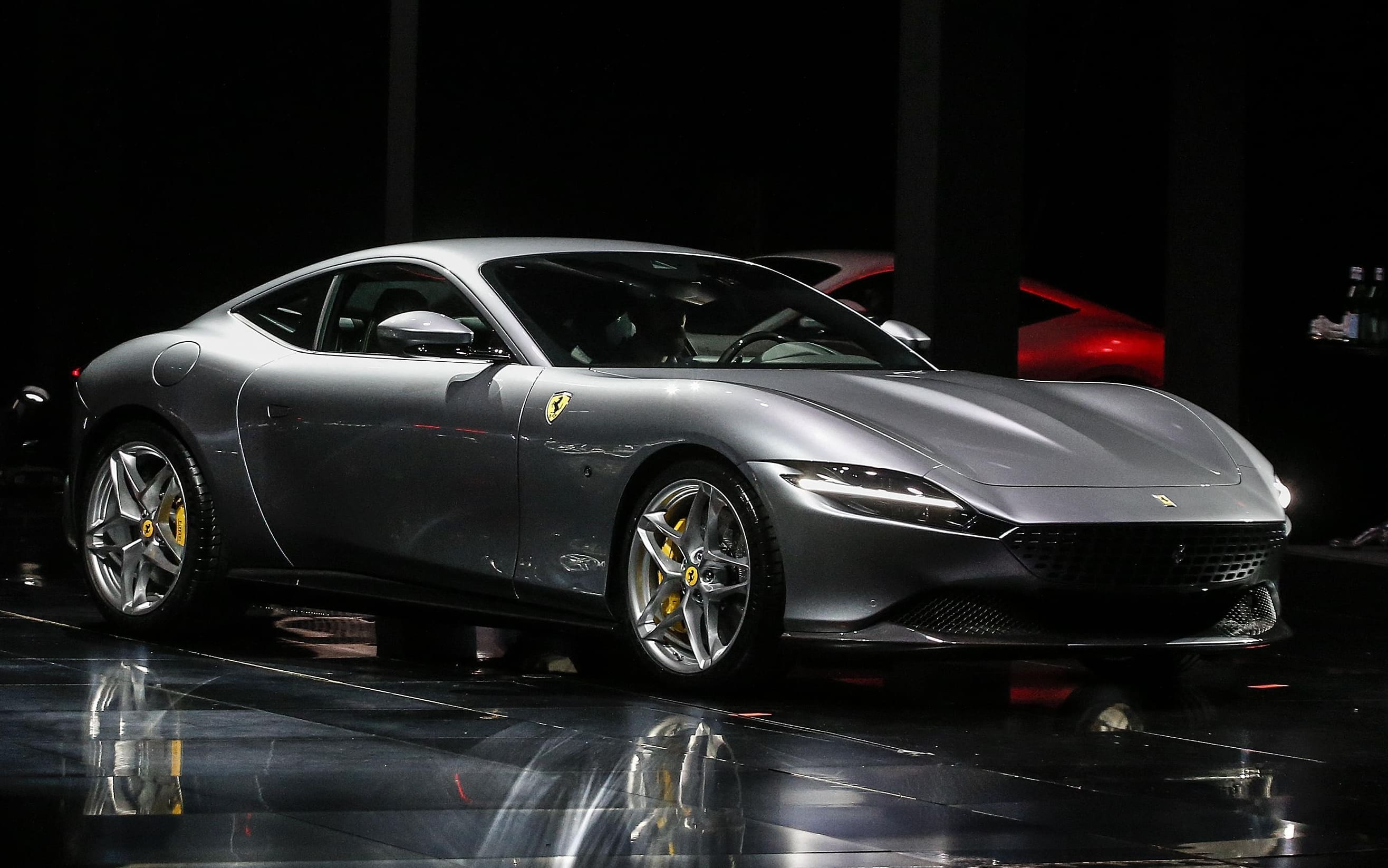 The Ferrari Roma car is unveiled in Rome, Thursday, Nov. 14, 2019. Ferrari unveils a new sports coupe aimed at enticing entry-level buyers and competing with the Porsche 911, part of a complete refresh of its model lineup by 2022. ANSA/FABIO FRUSTACI