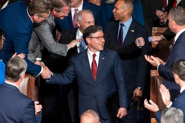 epa11804173 Republican Speaker of the House Mike Johnson (C) greets lawmakers as he re-enters the House chamber after winning the votes to maintain his position as Speaker of the House at the start of the 119th Congress in the US Capitol in Washington, DC, USA, 03 January 2025. The US House of Representatives begins its 119th session with an election for the next Speaker of the House, followed by a swearing-in for all members.  EPA/JIM LO SCALZO