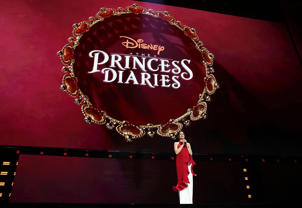ANAHEIM, CALIFORNIA - AUGUST 14: Anne Hathaway speaks onstage at the Disney Entertainment Showcase at D23: The Ultimate Disney Fan Event on August 14, 2026 in Anaheim, California. (Photo by Jesse Grant/Getty Images for Disney)