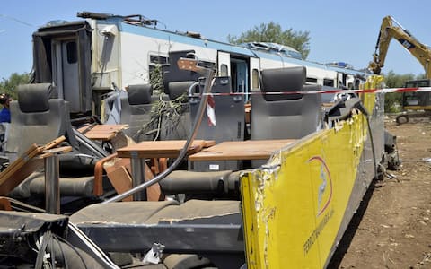 The trains wreckage are removed at the site of the head-on commuter train collision that occurred Tuesday between the towns of Andria and Corato, in the southern Puglia region, Italy, 13 July 2016. The official death toll of train crash is 23 fatalities and none missing, Governor Michele Emiliano said Wednesday based on a coroner's report. He said 52 wounded were treated and 24 remain hospitalized, eight of them in reserved prognosis. ANSA/ GAETANO LO PORTO