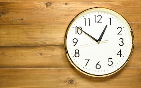 wall clock on the wooden wall early afternoon