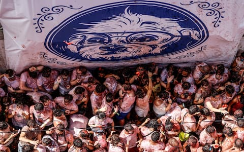 IPA87805438 - August 26, 2026, BuÃ±Ol, Valencia (Valencian Comm, Spain: Several participants in the Tomatina festival in BuÃ±ol celebrate during the event on 26 August 2026, in BuÃ±ol, Valencia, Valencian Community (Spain). La Tomatina is always held on the last Wednesday in August, as part of BuÃ±olâ€™s festival week, and involves participants throwing tomatoes at one another. Seven lorries were needed to transport the 150,000 kilos of tomatoes that were thrown in this unusual battle, which this year marks its 79th anniversary.[**********]..26 AUGUST 2026;CELEBRATIONS;TRADITION;FESTIVAL;EVENT;CULTURE..Rober Solsona / Europa Press..08/26/2026 (Credit Image: © Rober Solsona/Contacto via ZUMA Press)
