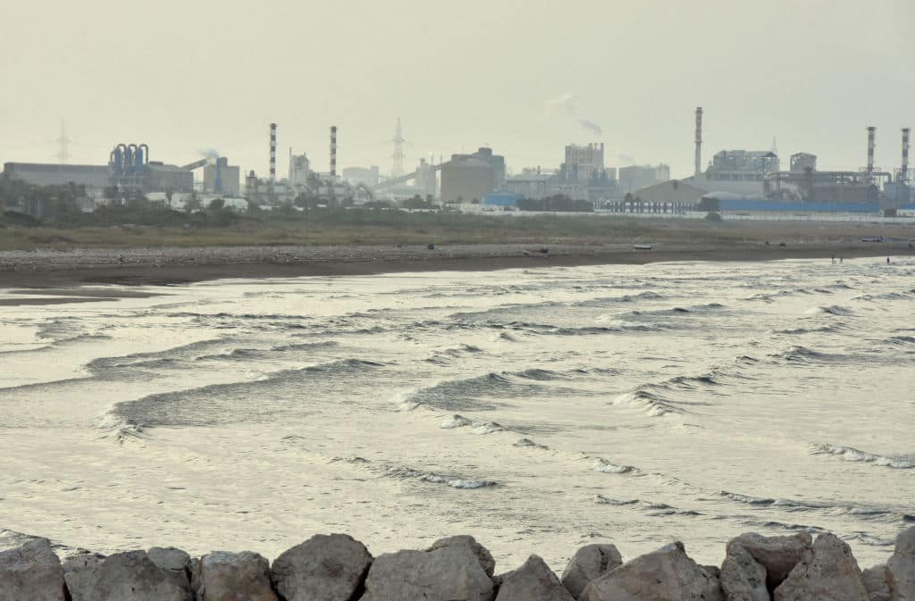 A picture shows on July 20, 2017 the state-owned Tunisian Chemical Group (GCT)'s phosphate processing plant close to the Chott Essalem beach and in front of a rare coastal oasis in Gabes. - The authorities say the plant pumps 14,000 tonnes of phosphogypsum into the sea every day. On top of the toxic mud, the factory also pumps phosphoric acid into the air. (Photo by STRINGER / AFP) (Photo by STRINGER/AFP via Getty Images)