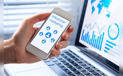 Inlfuencer marketing concept on a mobile phone screen with a diagram showing a social network advertising strategy with communication to people