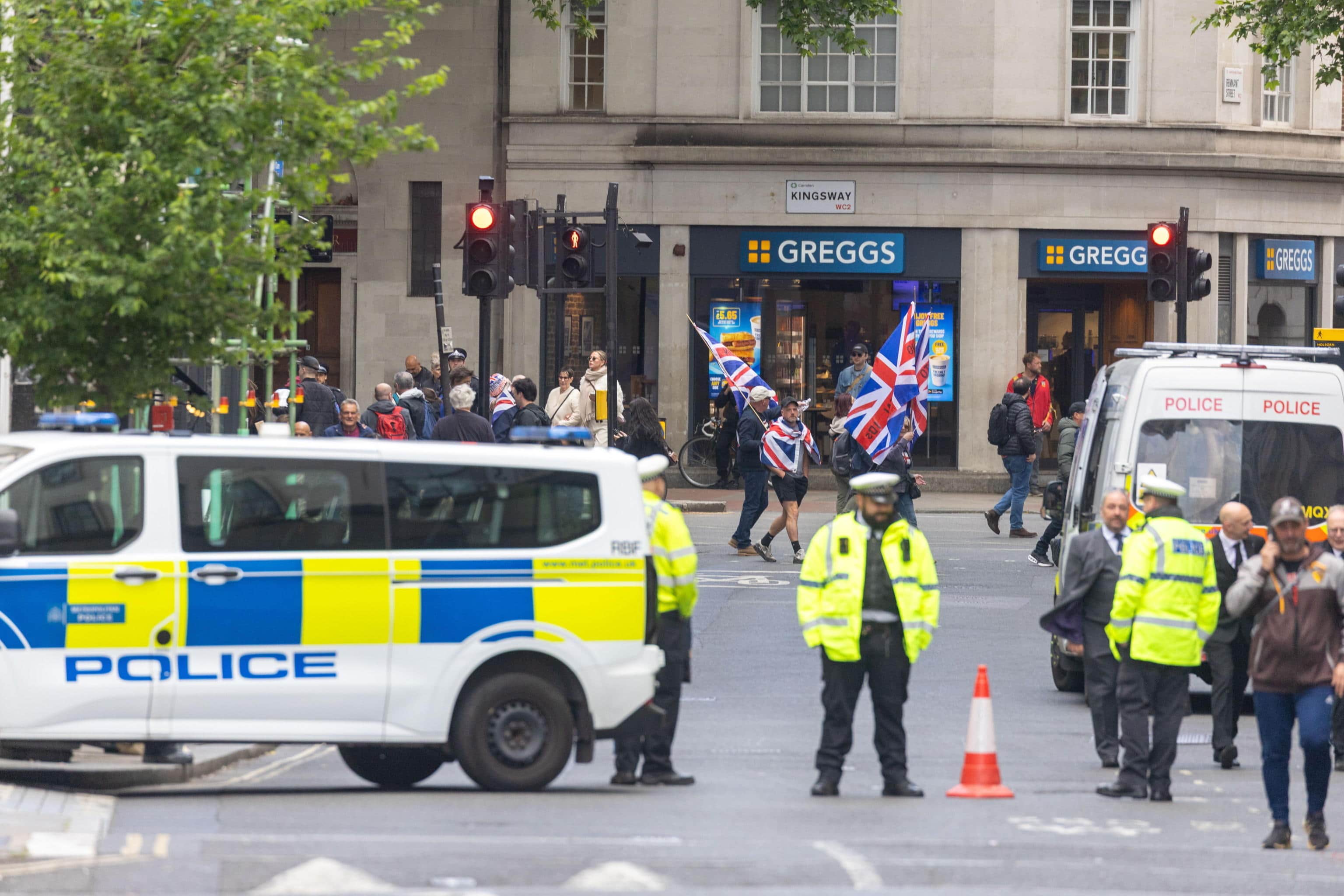 epa12962296 Police take security measures as people gather in Kingsway ahead of a 'Unite the Kingdom' march and rally in London, Britain, 16 May 2026. The march is organized by Stephen Yaxley-Lennon, also known as Tommy Robinson, to call for a new coalition to 'Make Europe Great Again.' This protest is taking place at the same time as a 'Nakba 78: March for Palestine' in London.  EPA/TAYFUN SALCI