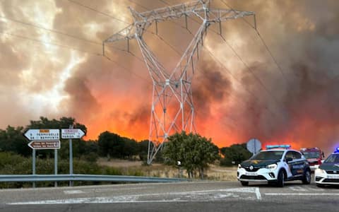 epa13141103 A handout photo made available by the Spanish Civil Guard shows Spanish Civil Guard blocking a road during a wildfire in Fermoselle, Zamora, Spain, 30 July 2026.  EPA/SPANISH CIVIL GUARD / HANDOUT MANDATORY CREDIT HANDOUT EDITORIAL USE ONLY/NO SALES