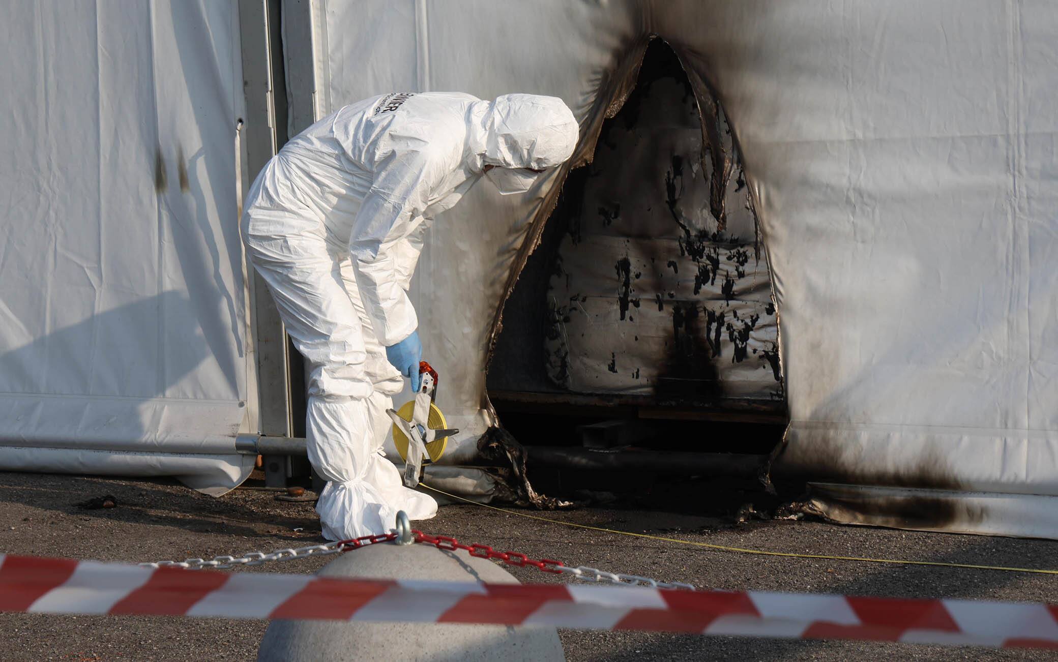 The scientific police and firefighters on the spot where two incendiary bottles were thrown at the structure that houses the tampon center and anti-Covid vaccination center in Brescia, Italy, 03 April 2021. The investigations are entrusted to the police who are trying to reconstruct what happened also through the security cameras installed on the street.ANSA/FILIPPO VENEZIA