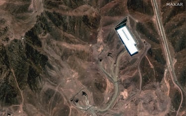 FORDOW FACILITY, IRAN -- JUNE 16, 2025: 04 -- Maxar satellite image captures a close-up of the Fordow fuel enrichment site, focusing on tunnel entrances and a large secondary building embedded in the mountainous terrain. Please use: Satellite image (c) 2025 Maxar Technologies.