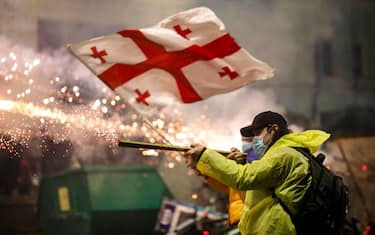 epa11750576 Georgian opposition supporters launch fireworks towards the police during a protest in front of the Parliament building in Tbilisi, Georgia, 30 November 2024. Thousands of pro-EU activists demonstrated in the Georgian capital of Tbilisi to protest against the country's ruling party decision to suspend accession talks with the European Union (EU) until the end of 2028.  EPA/DAVID MDZINARISHVILI