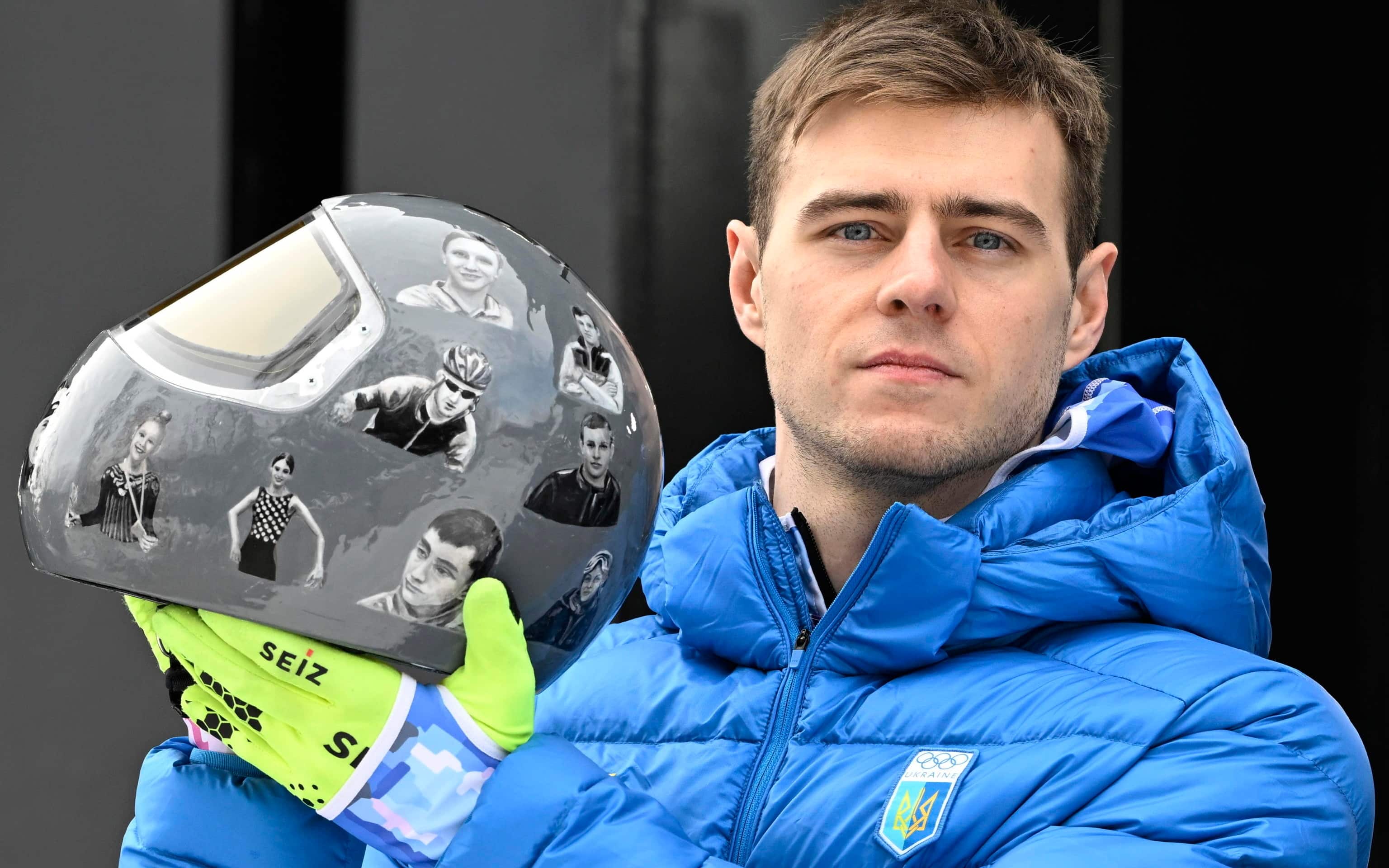 epa12726796 Vladyslav Heraskevych of Ukraine shows his helmet in memory of the Ukrainian athletes who died in the war during the Men's Skeleton training session at the Milano Cortina 2026 Winter Olympic Games, in Cortina d'Ampezzo, Italy, 11 February 2026.  EPA/DANIEL DAL ZENNARO