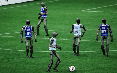 epa13184798 Humanoid robots play a football match during the 2026 World Humanoid Robot Games opening ceremony at the National Speed Skating Oval in Beijing, China, 22 August 2026. The 2026 World Humanoid Robot Games are being held in Beijing until 26 August.  EPA/WU HAO