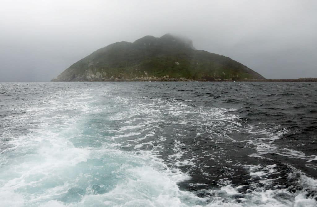 This September 30, 2016 picture shows a view of Okinoshima island, some 60 kilometres from Munakata city, Fukuoka prefecture. - The island of Okinoshima and associated sites in the Munakata Region have been inscribed at the 41st session of the UNESCO World Heritage Committee held in Poland on July 9, 2017. (Photo by JIJI PRESS / AFP) / Japan OUT (Photo by STR/JIJI PRESS/AFP via Getty Images)