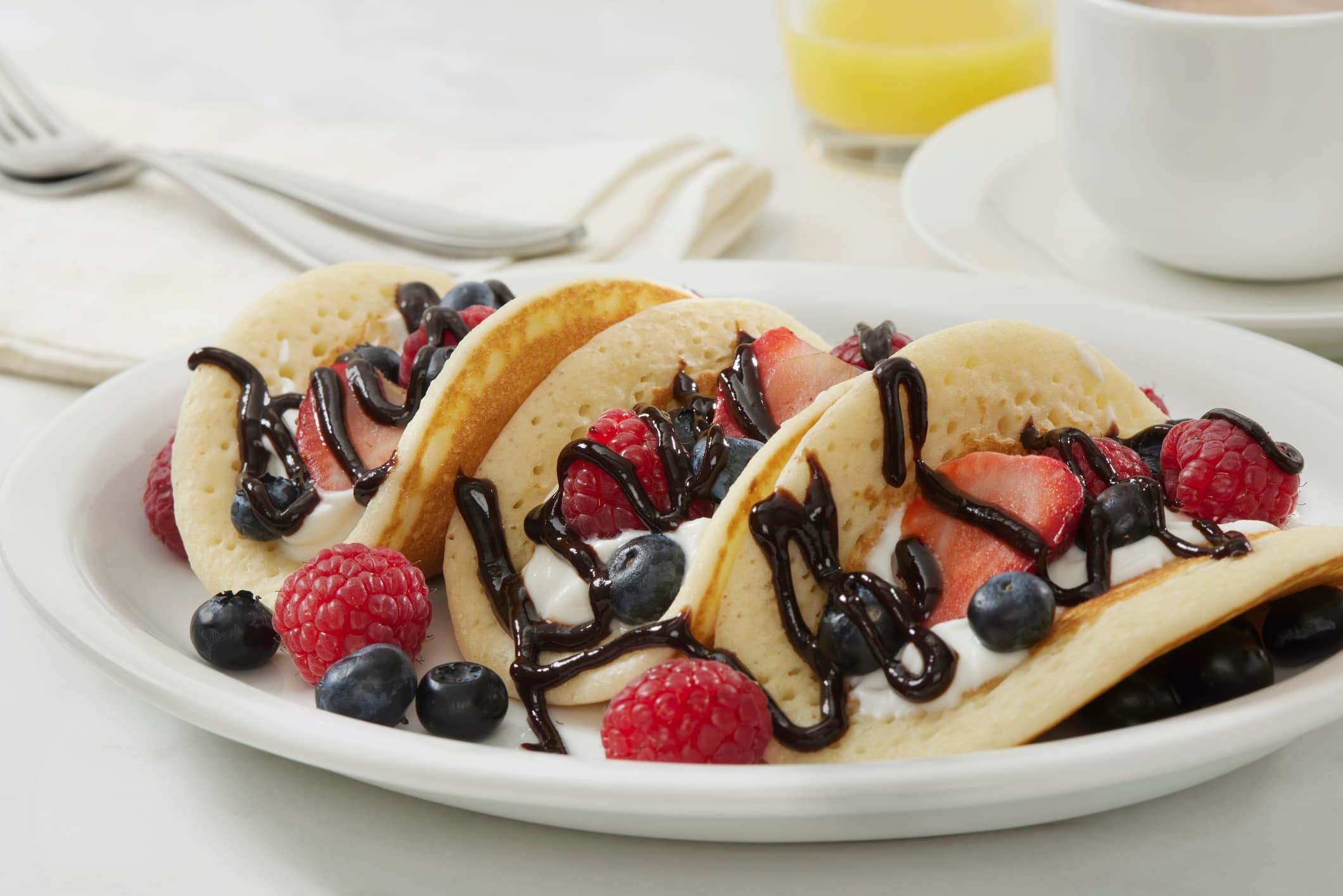 The Viral Pancake Breakfast Taco with Yogurt, Strawberry's, Raspberry's, Blueberries and Chocolate Sauce