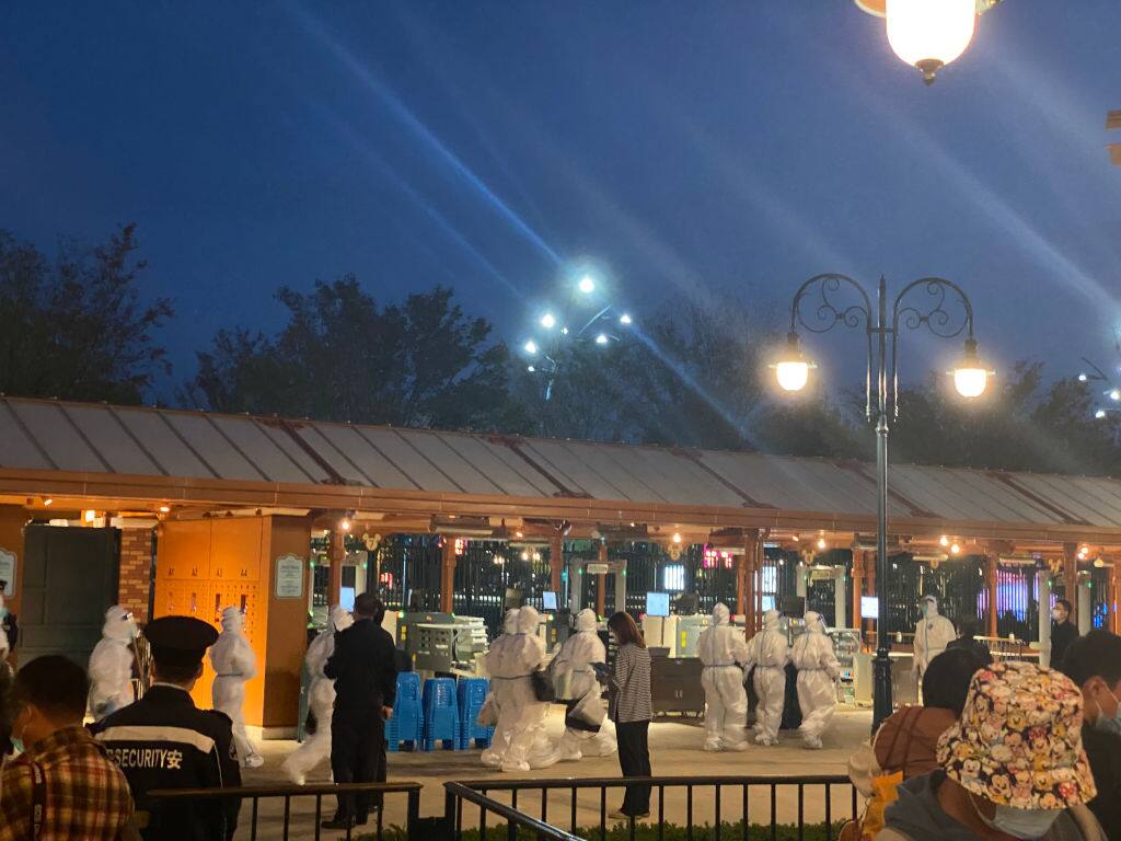 SHANGHAI, CHINA - OCTOBER 31: Tourists wait to receive COVID-19 nucleic acid test at Shanghai Disney Resort on October 31, 2021 in Shanghai, China. Shanghai Disney Resort conducted on-site nucleic acid tests for over 33,000 people on Sunday night. (Photo by VCG/VCG via Getty Images)